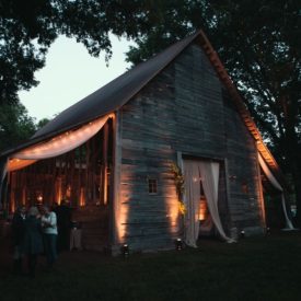 Barn draped and light at night.